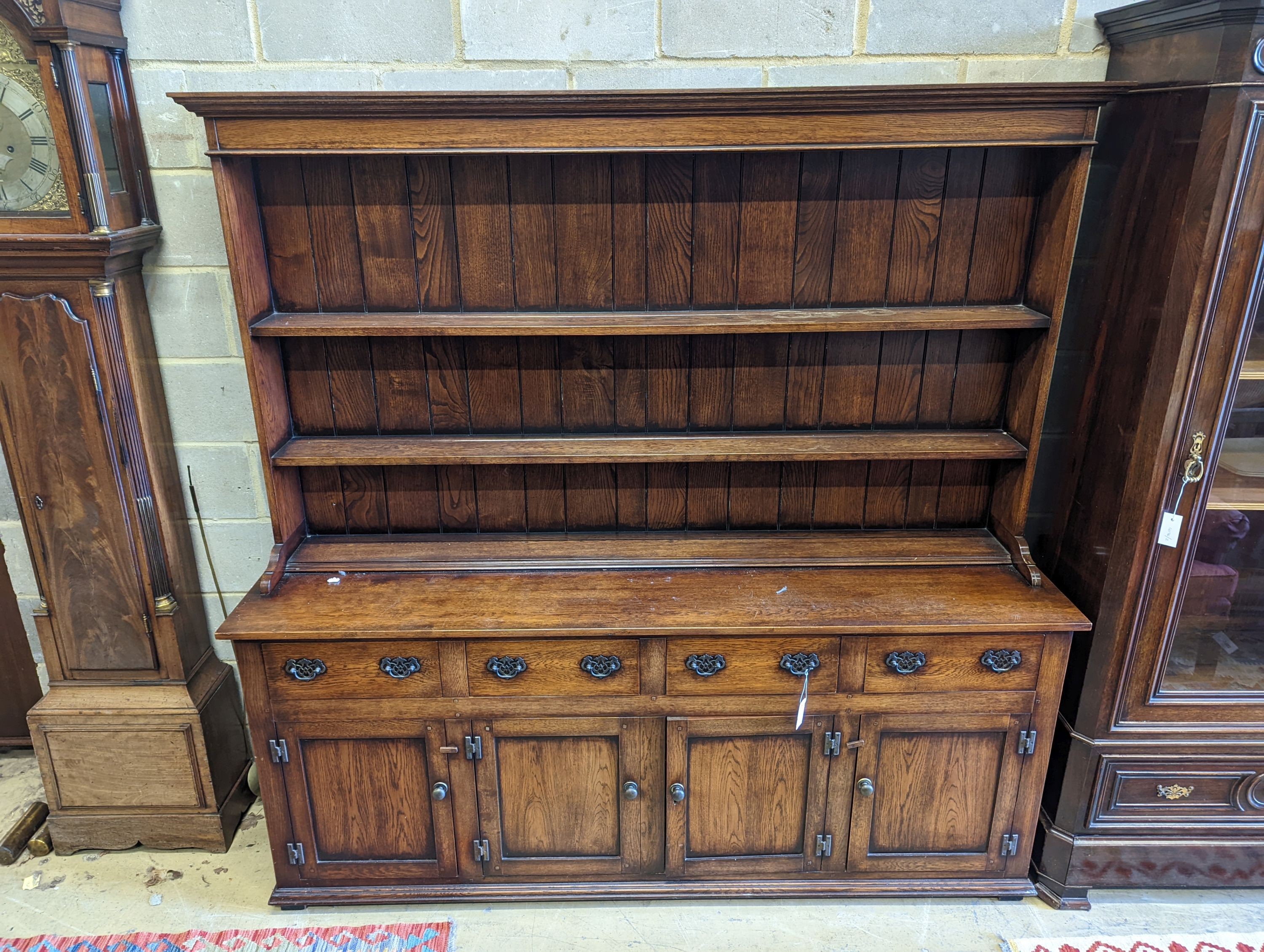 An 18th century style oak dresser with boarded plate rack, width 199cm, depth 48cm, height 198cm